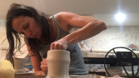 Person sculpting clay.